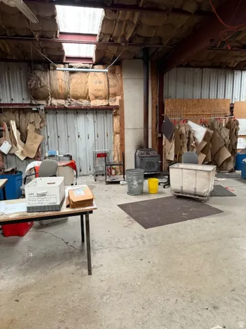 Unfinished below grade area featuring a wood stove
