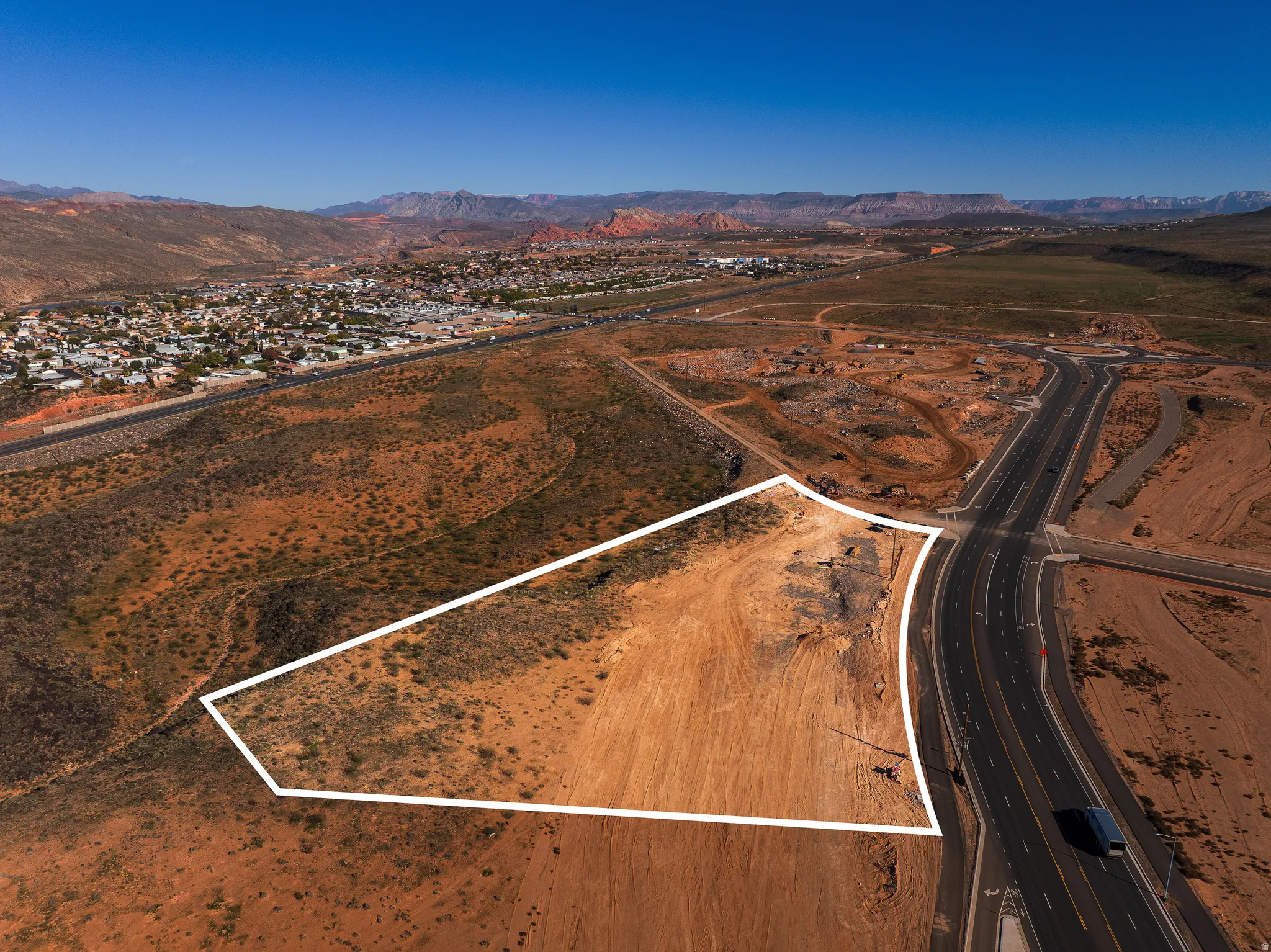 Overview of rural landscape featuring a mountainous background and property parcel outlined