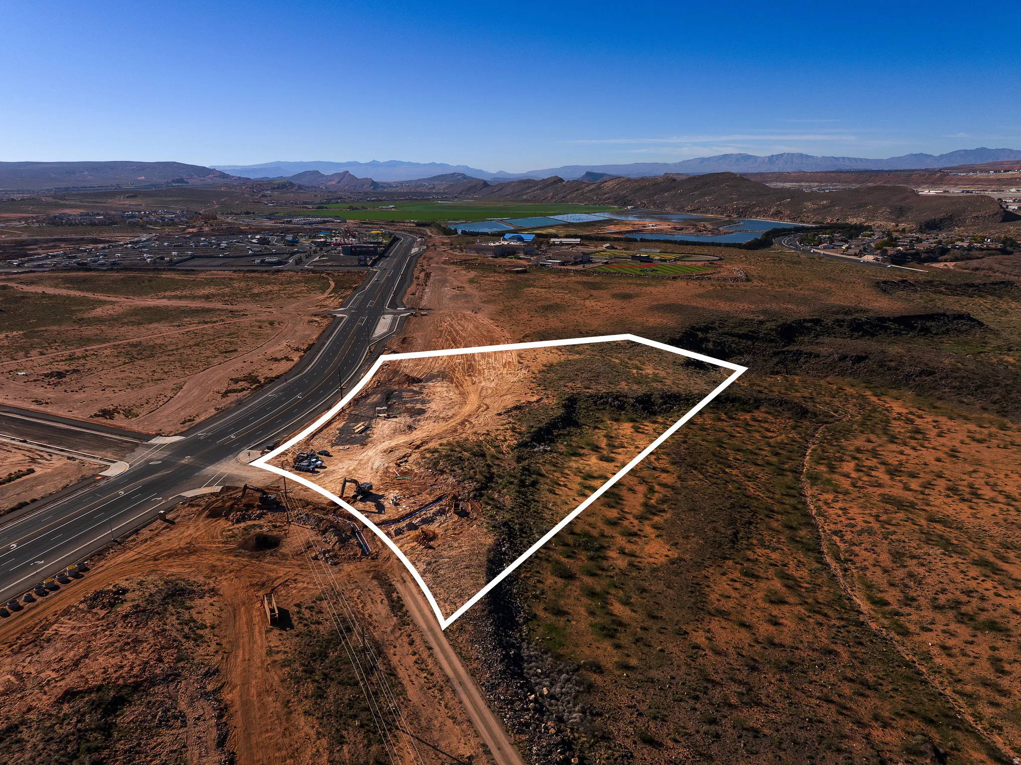 Aerial view of property's location with property parcel outlined and a water and mountain view
