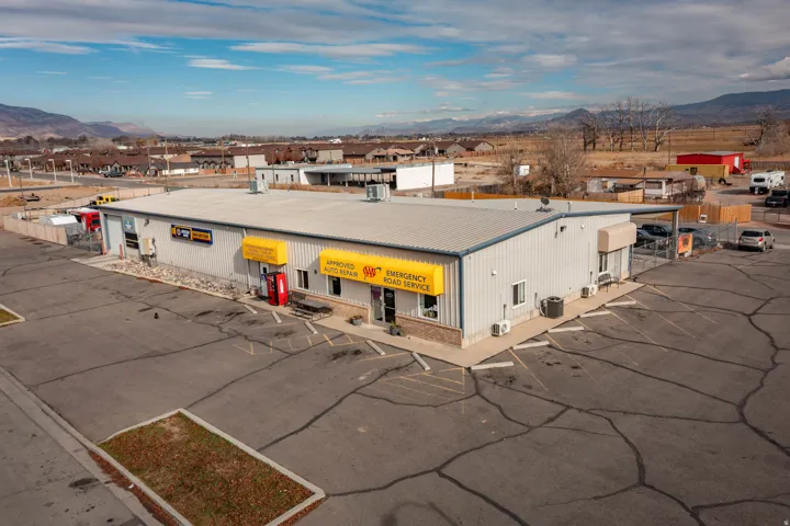 View of commercial property with a mountain view and uncovered parking