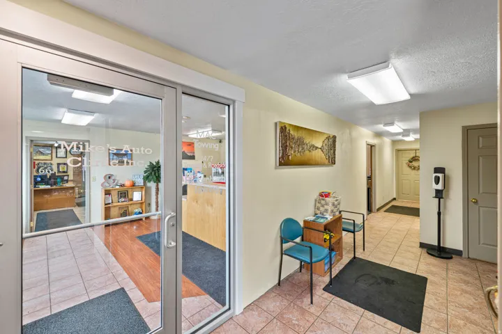 Doorway featuring tile patterned flooring and a textured ceiling