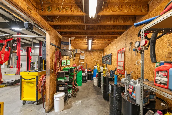 Misc room with unfinished concrete floors and a workshop area