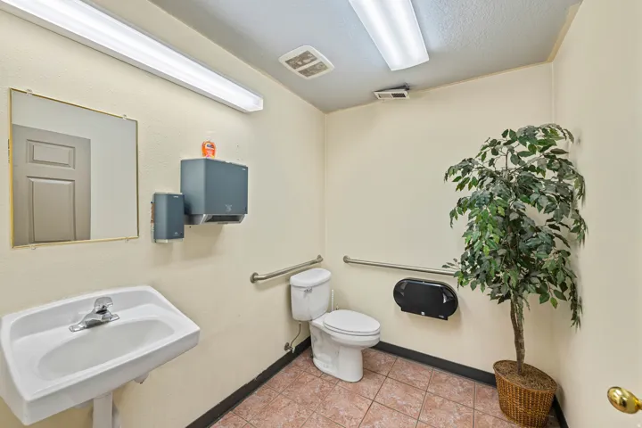 Half bathroom with light tile patterned flooring and a textured ceiling