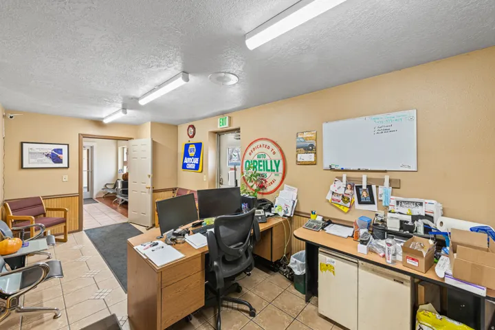 Office space featuring a textured ceiling and wainscoting