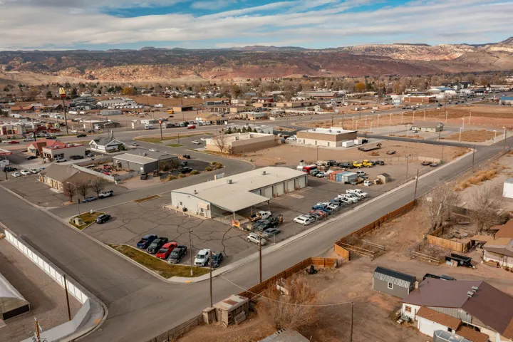 Drone / aerial view of industrial structures and a mountain backdrop