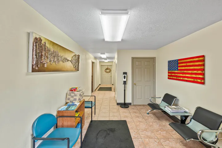 Sitting room with a textured ceiling and light tile patterned flooring