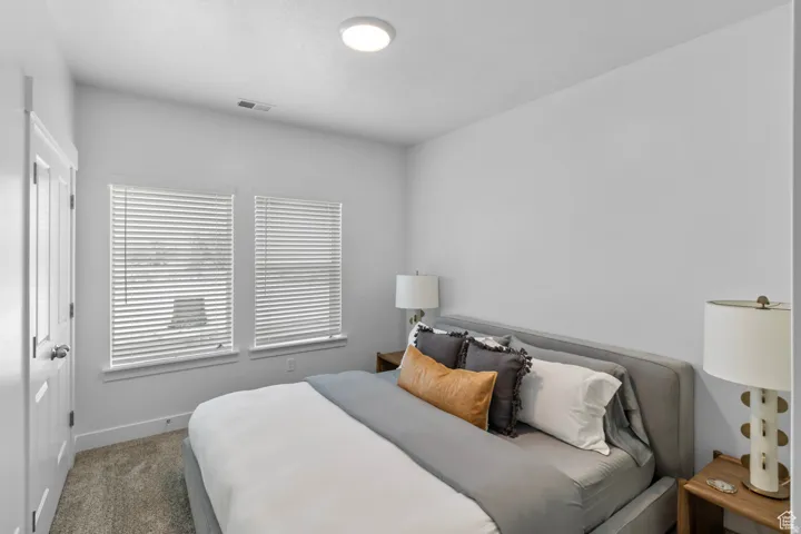 Bedroom with carpet floors and baseboards