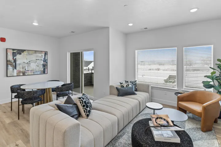 Living area featuring light wood-style floors and recessed lighting