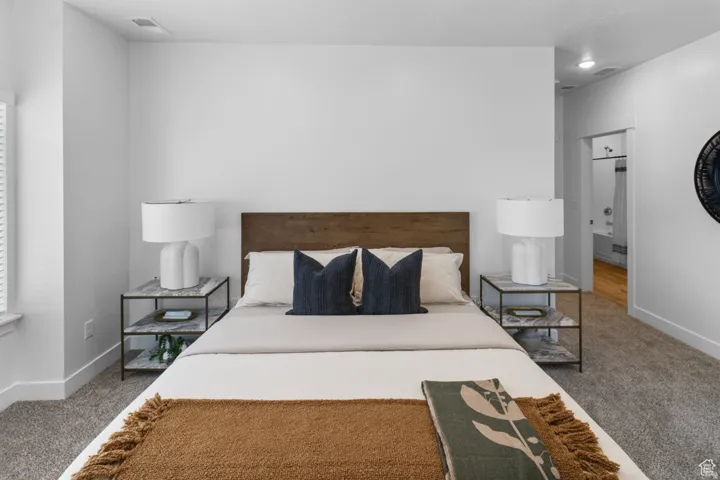 Carpeted bedroom with baseboards
