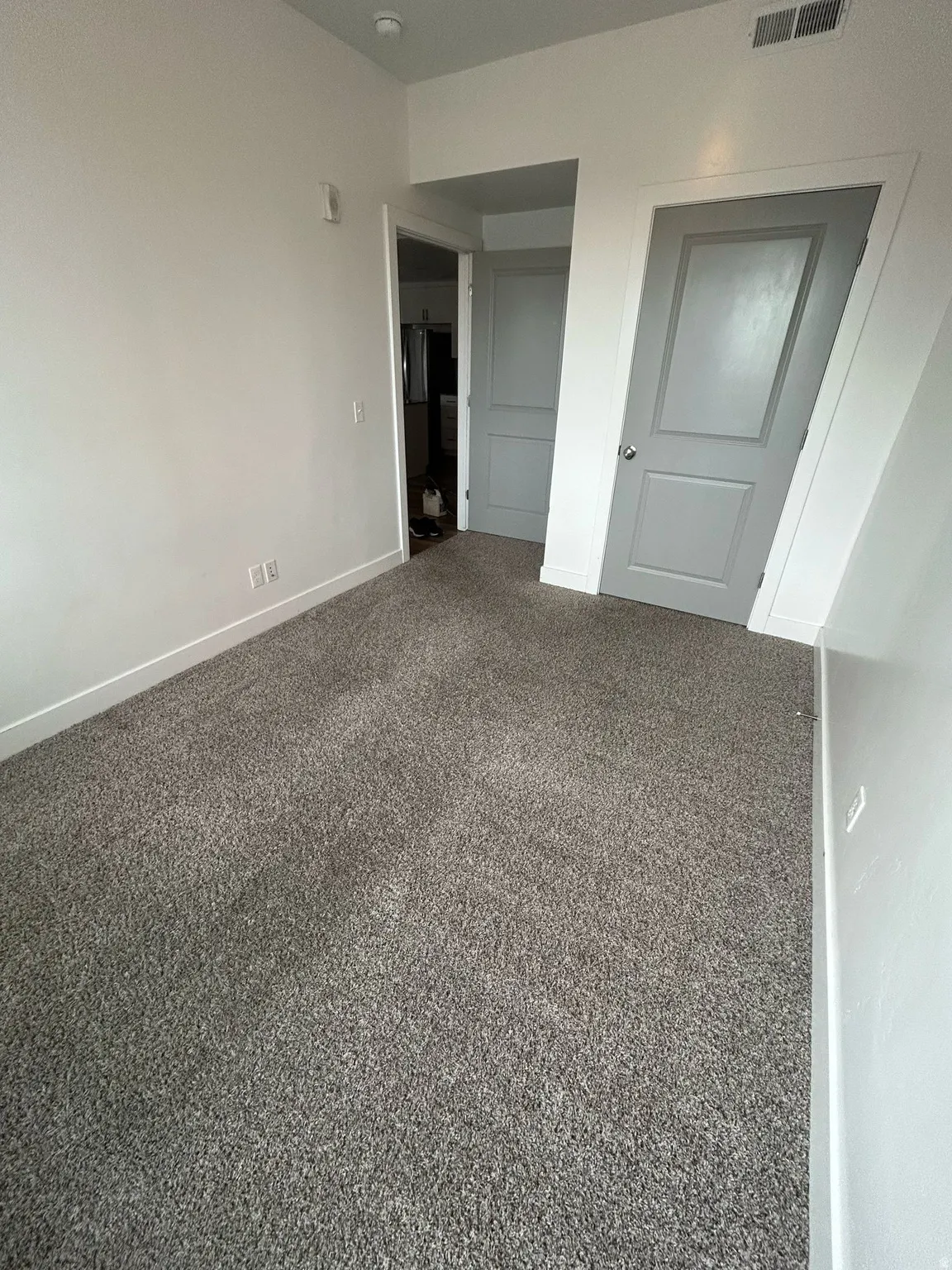Unfurnished bedroom with carpet flooring and baseboards
