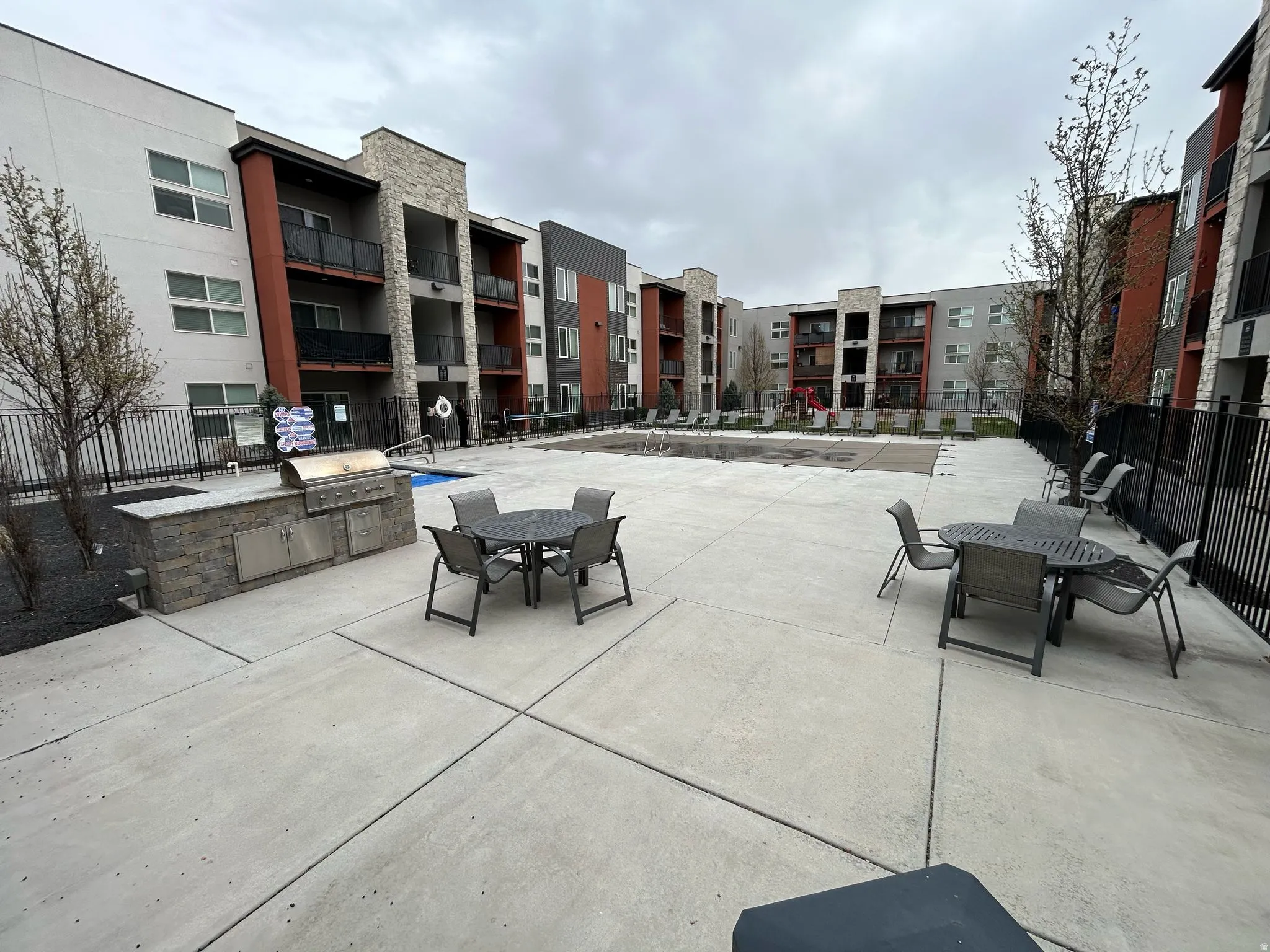 View of patio with outdoor dining area and area for grilling
