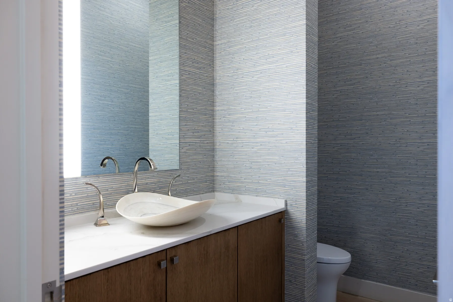 Half bathroom with vanity and toilet