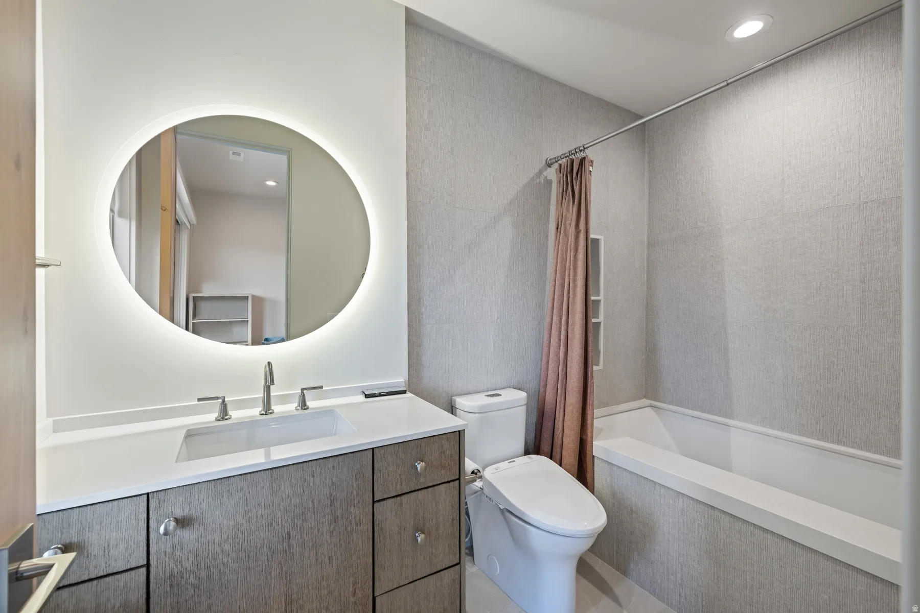 Bathroom with vanity, recessed lighting, and shower / bathtub combination with curtain