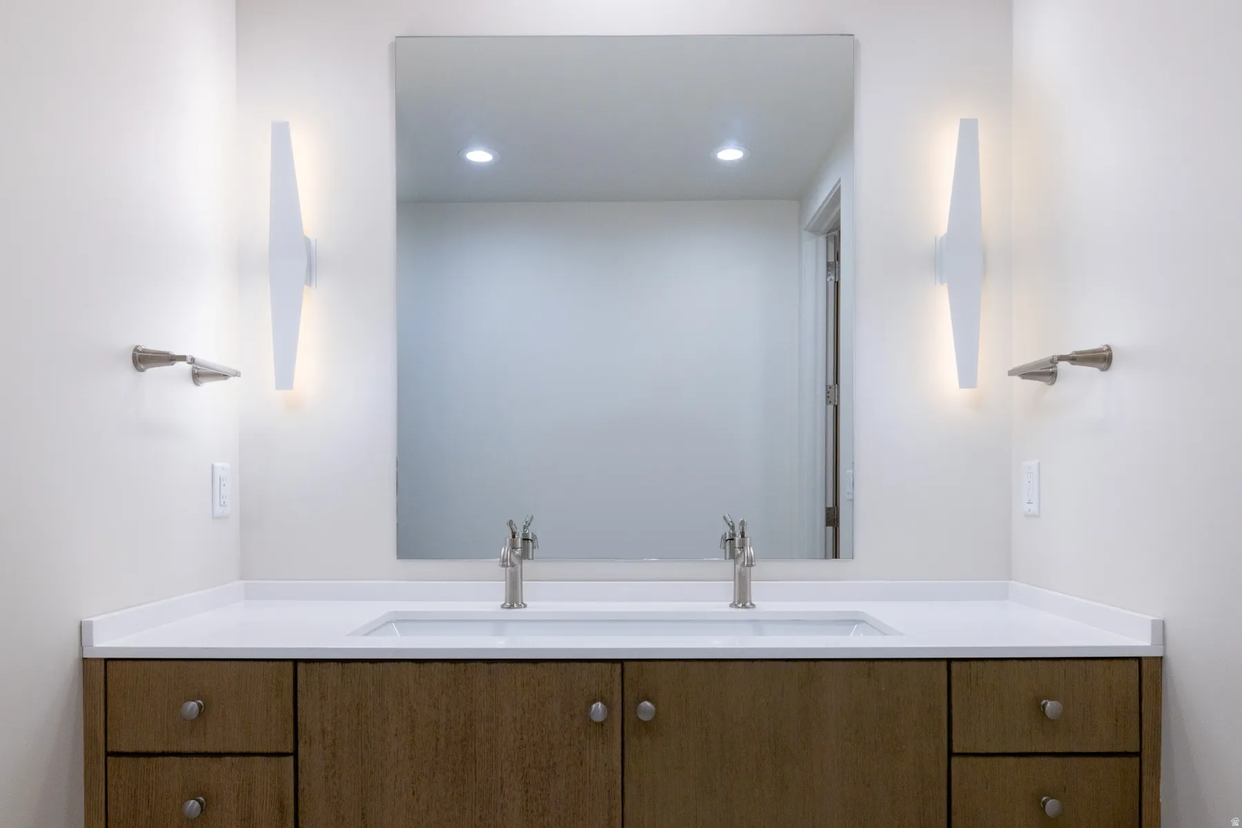 Bathroom featuring double vanity and recessed lighting