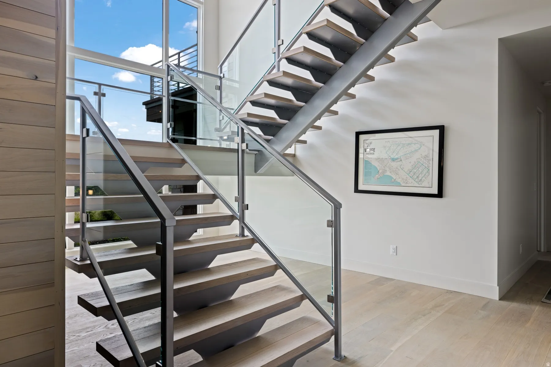 Stairs featuring wood finished floors and baseboards
