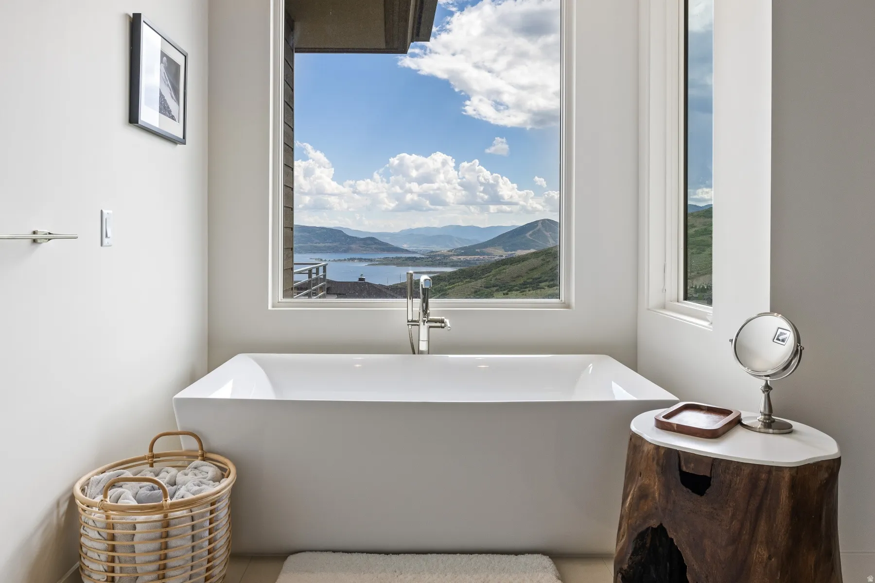 Full bath with a freestanding tub and a mountain view