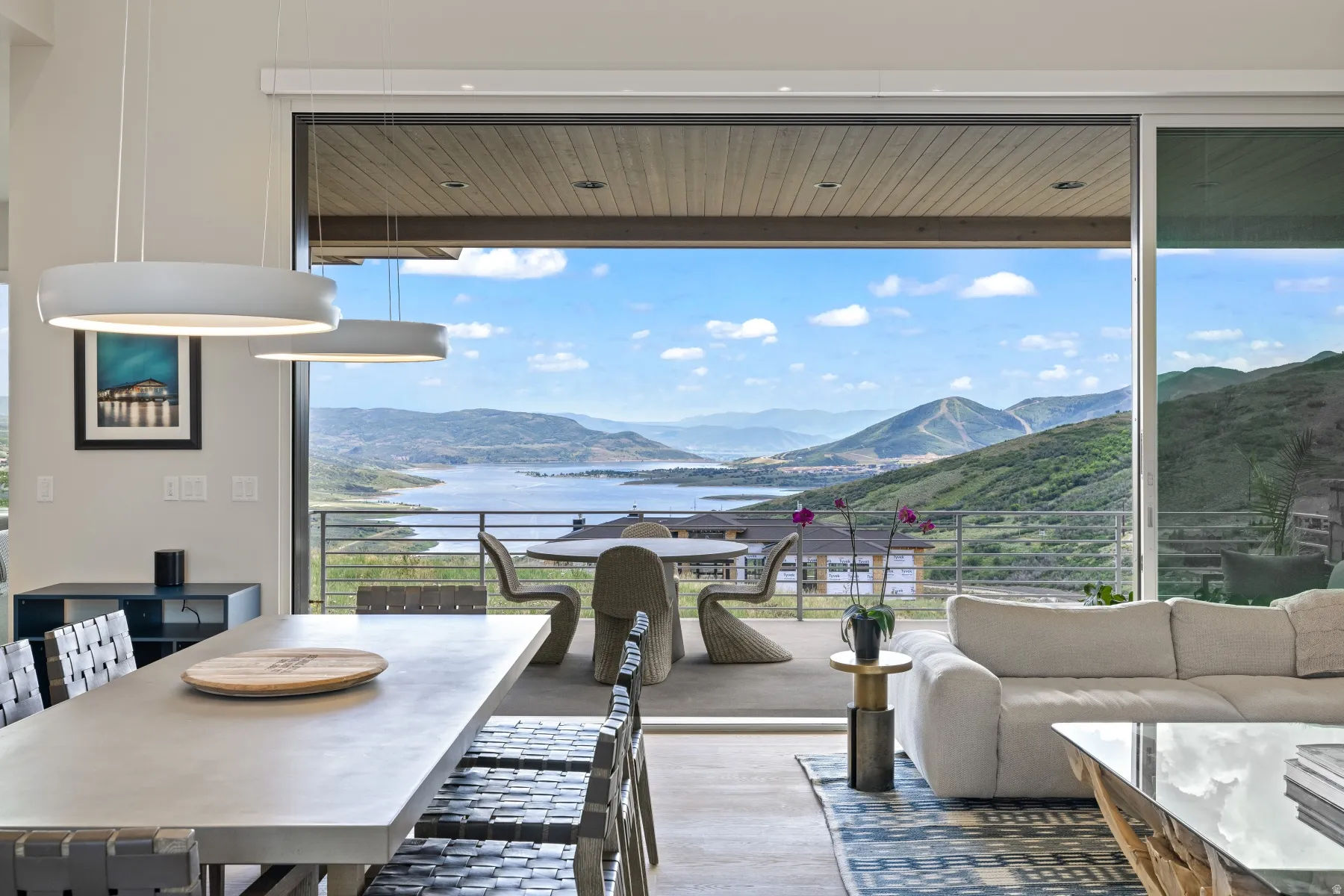 Dining area with wood finished floors, expansive windows, and a water and mountain view