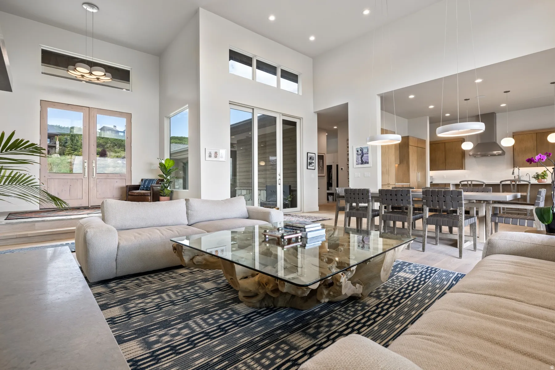Living room featuring a high ceiling, plenty of natural light, french doors, and recessed lighting