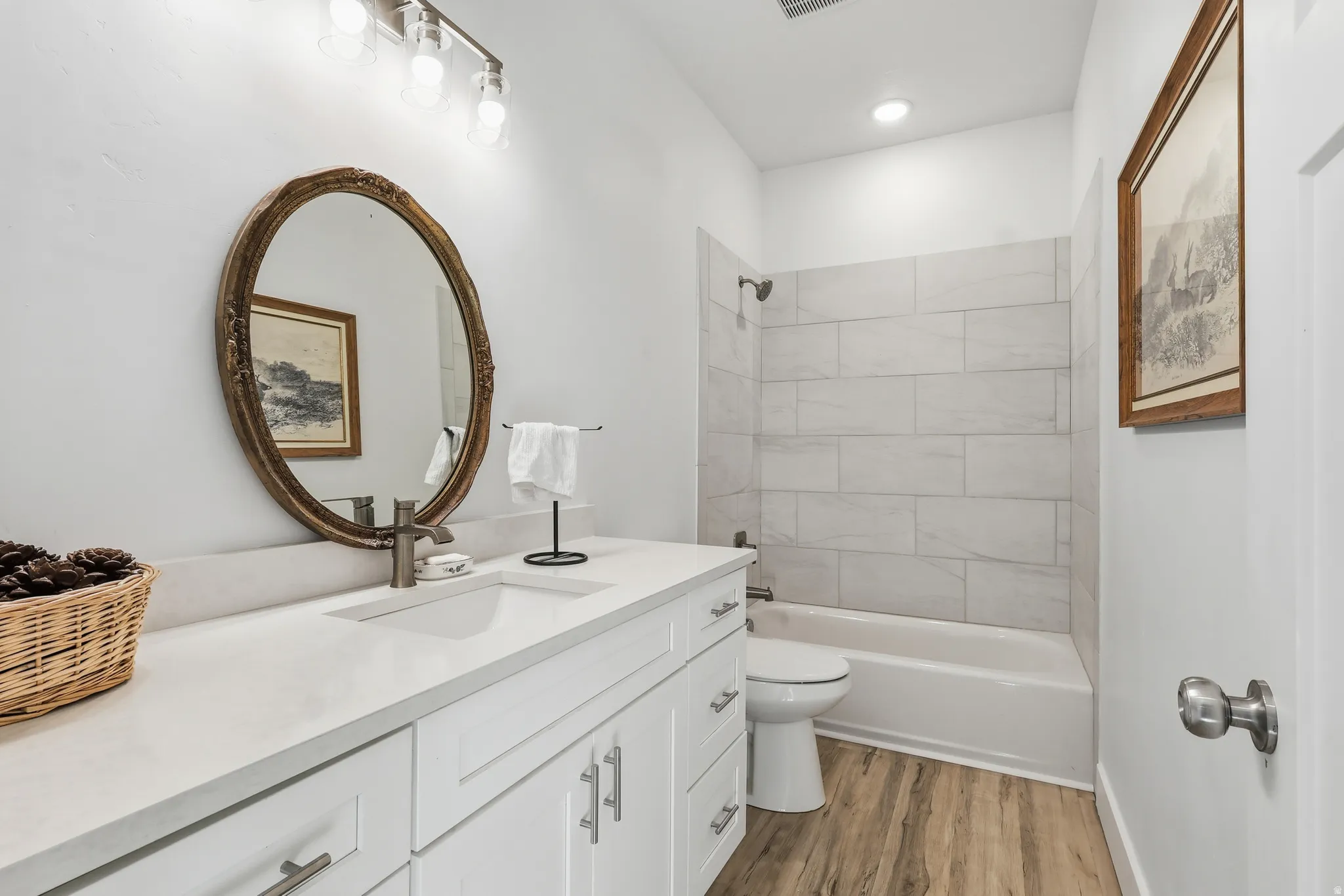 Full bath featuring vanity, shower / washtub combination, and light wood-type flooring