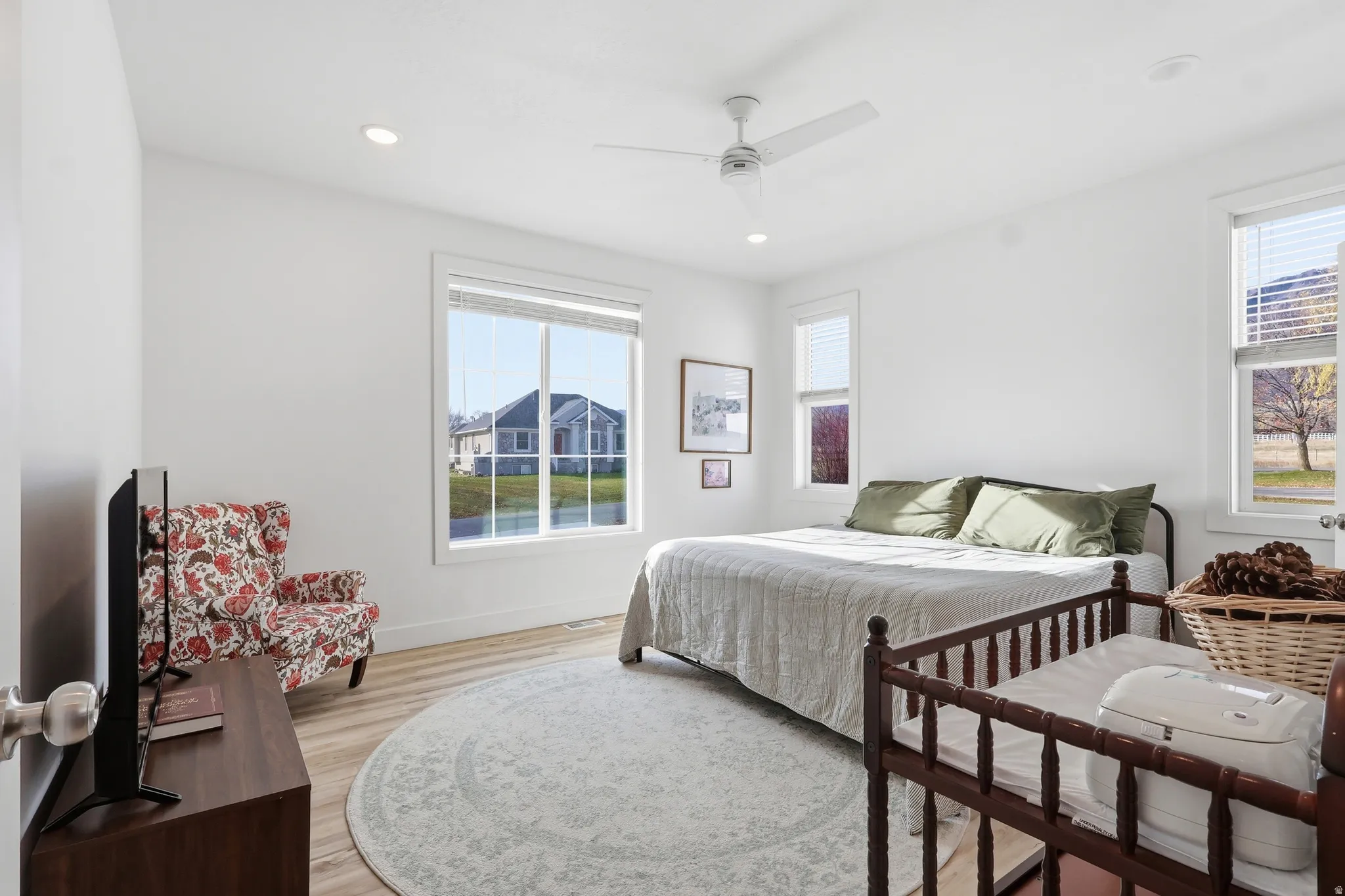 Bedroom featuring light wood-style floors, ceiling fan, and recessed lighting