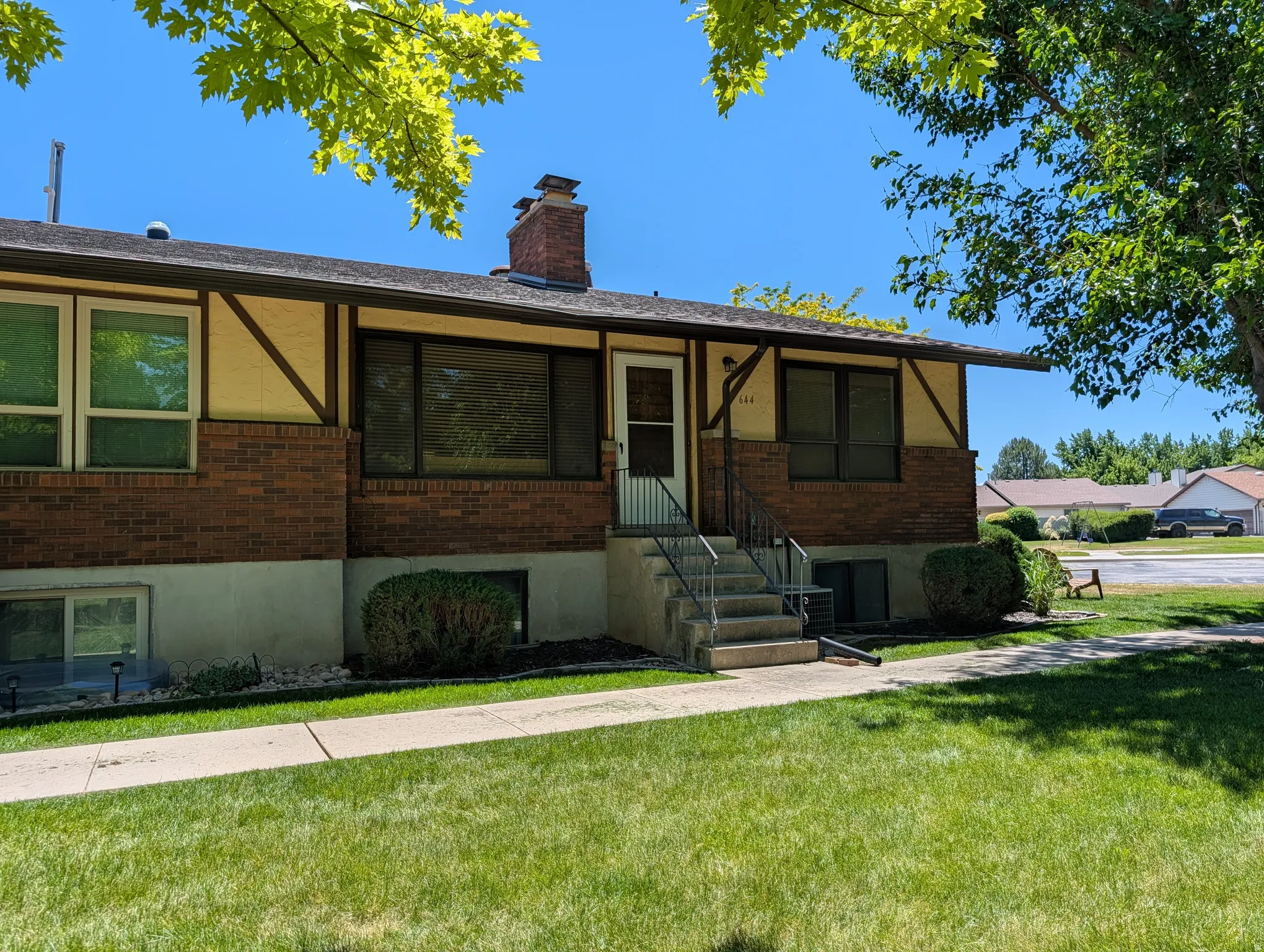 Split-level residence featuring brick and stucco siding