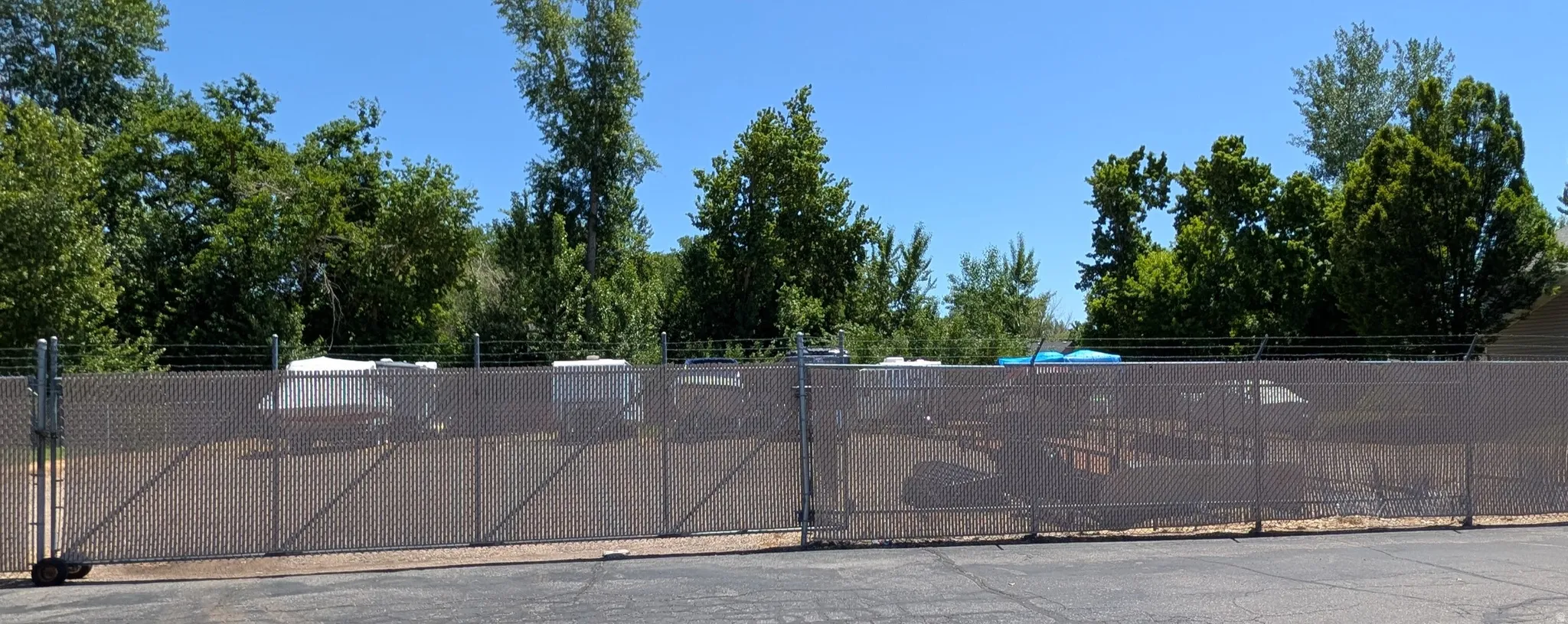 Secure chain-link fencing with barbed wire topping