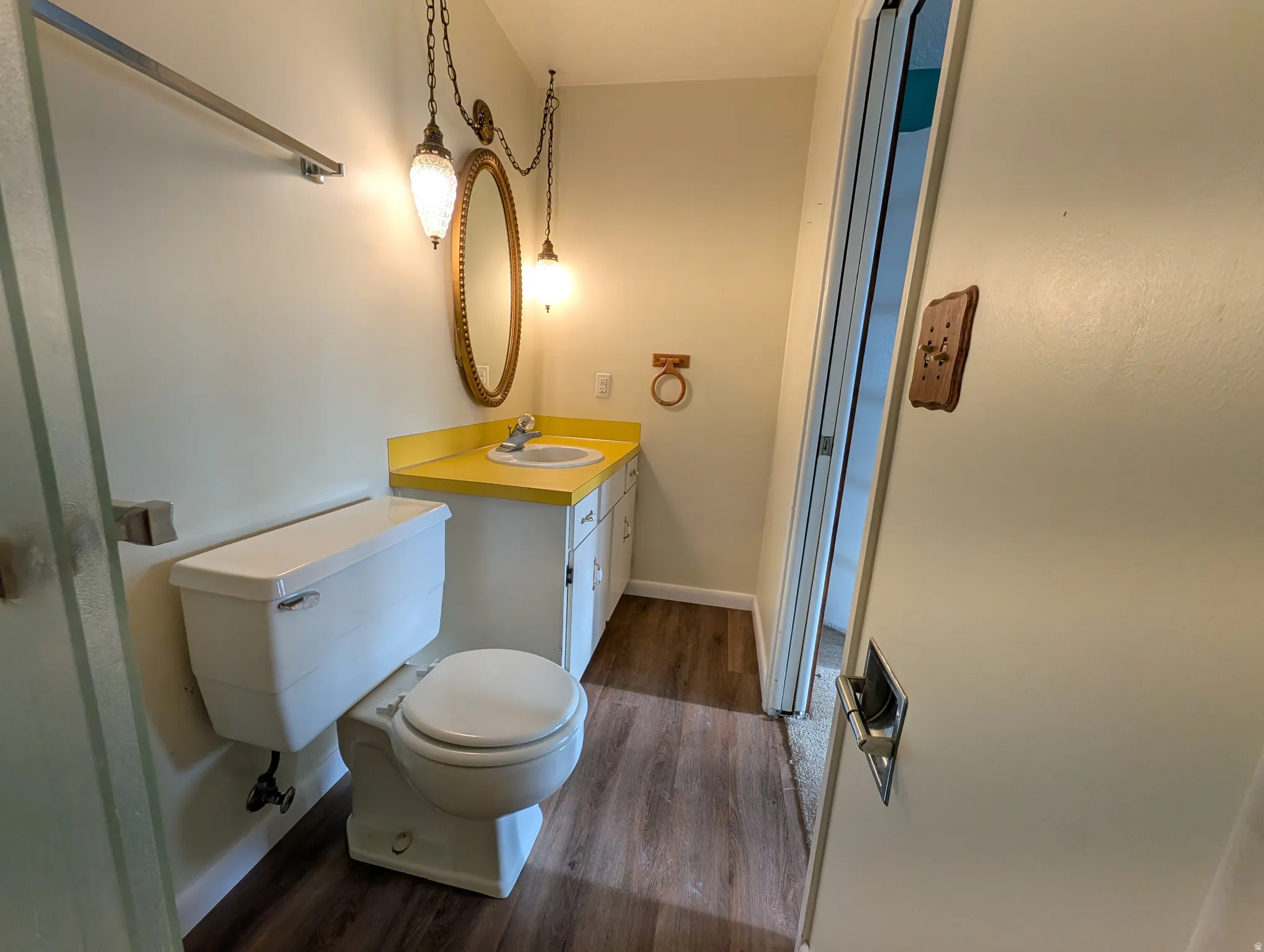 Bathroom with vanity and dark wood-style floors