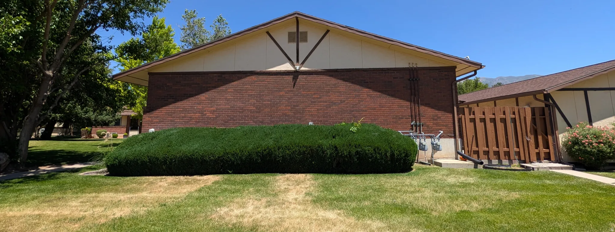 Brick exterior featuring a gabled roofline and decorative gable truss