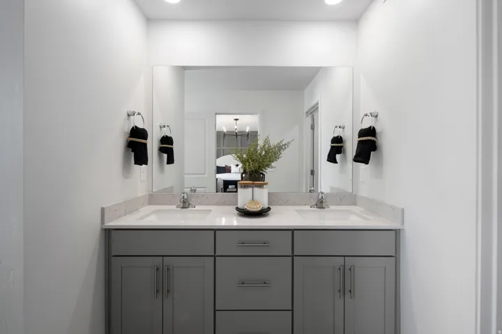 Full bath featuring double vanity and ensuite bathroom