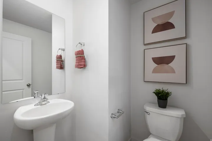 Half bath featuring toilet and a sink