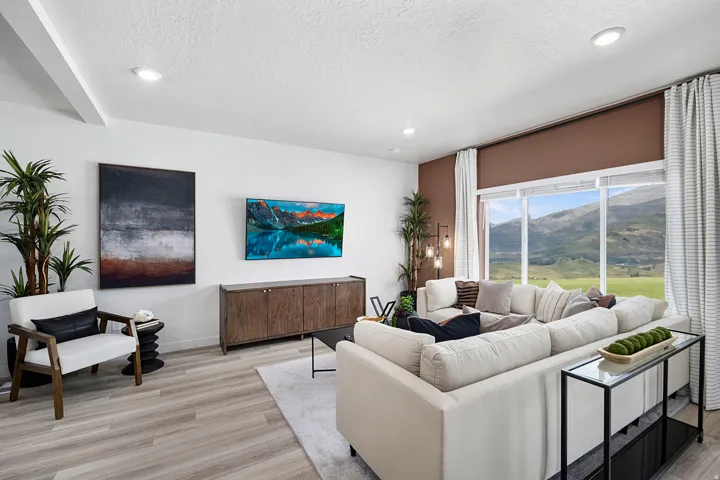Living area featuring light wood-style flooring, recessed lighting, and a textured ceiling