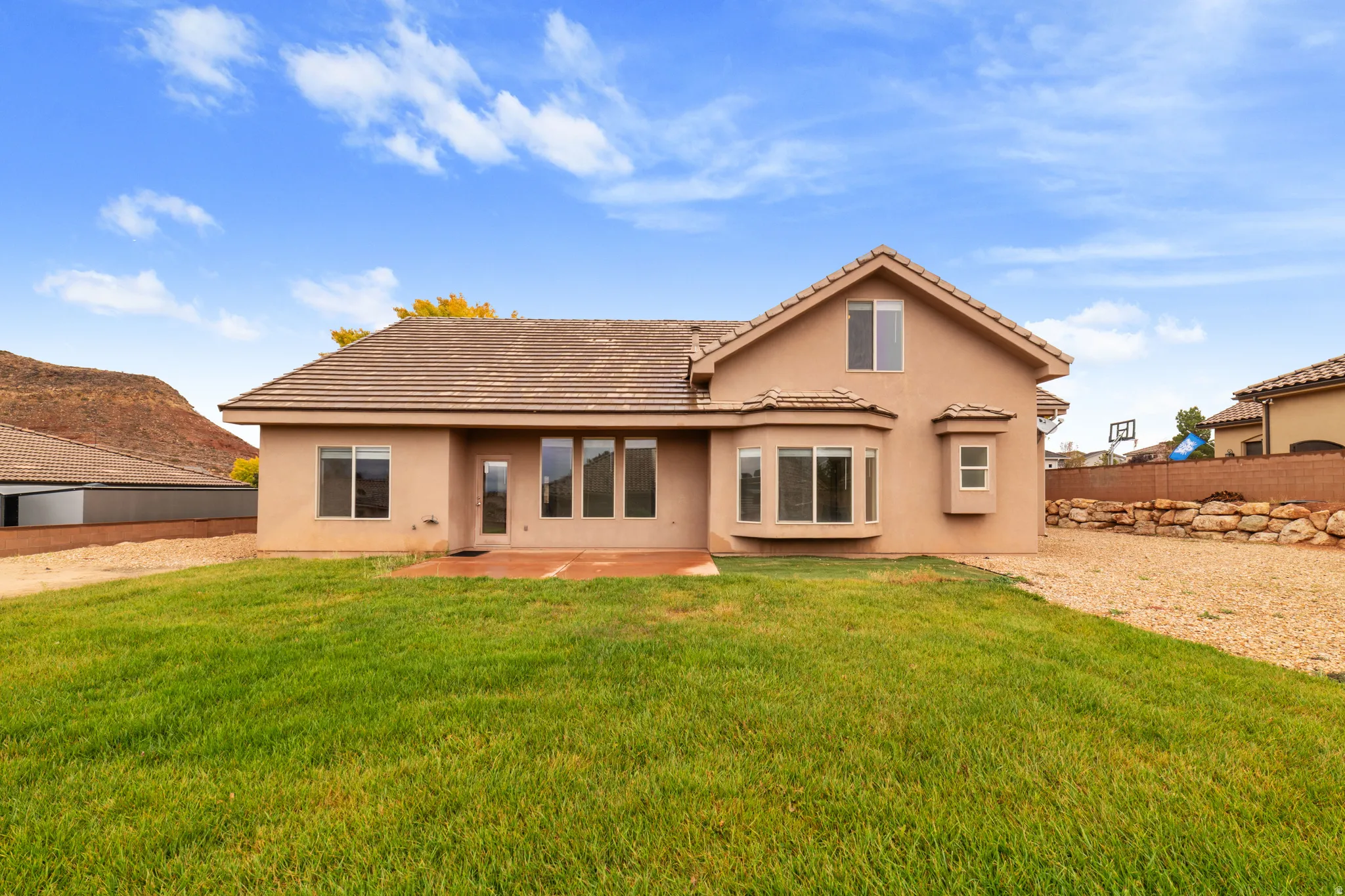 Rear view of property featuring stucco siding and a patio area