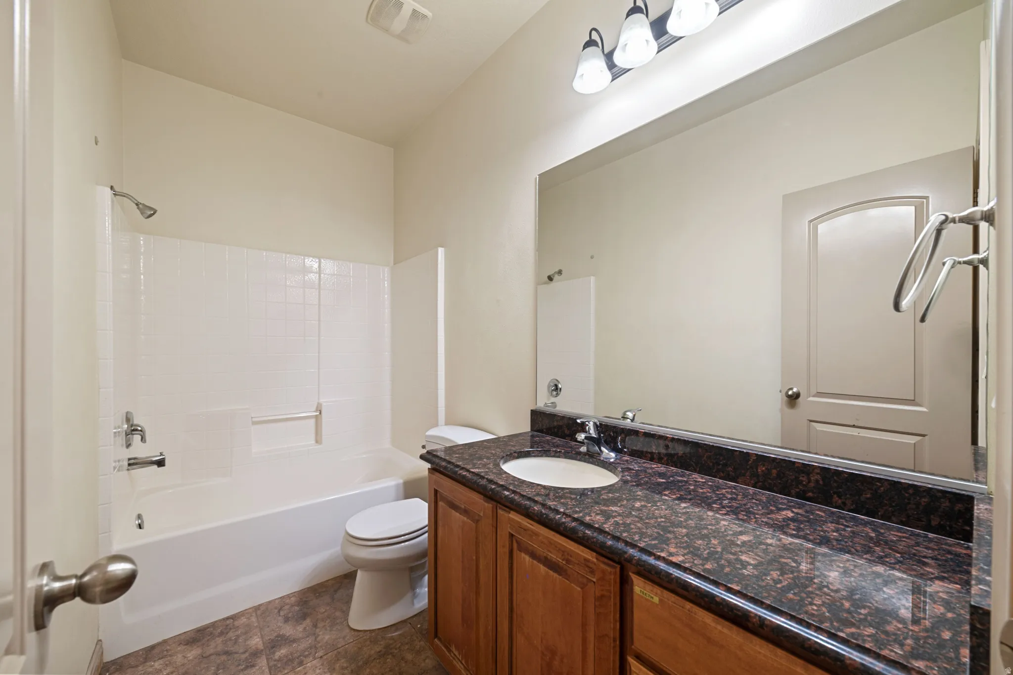 Bathroom featuring vanity and bathtub / shower combination