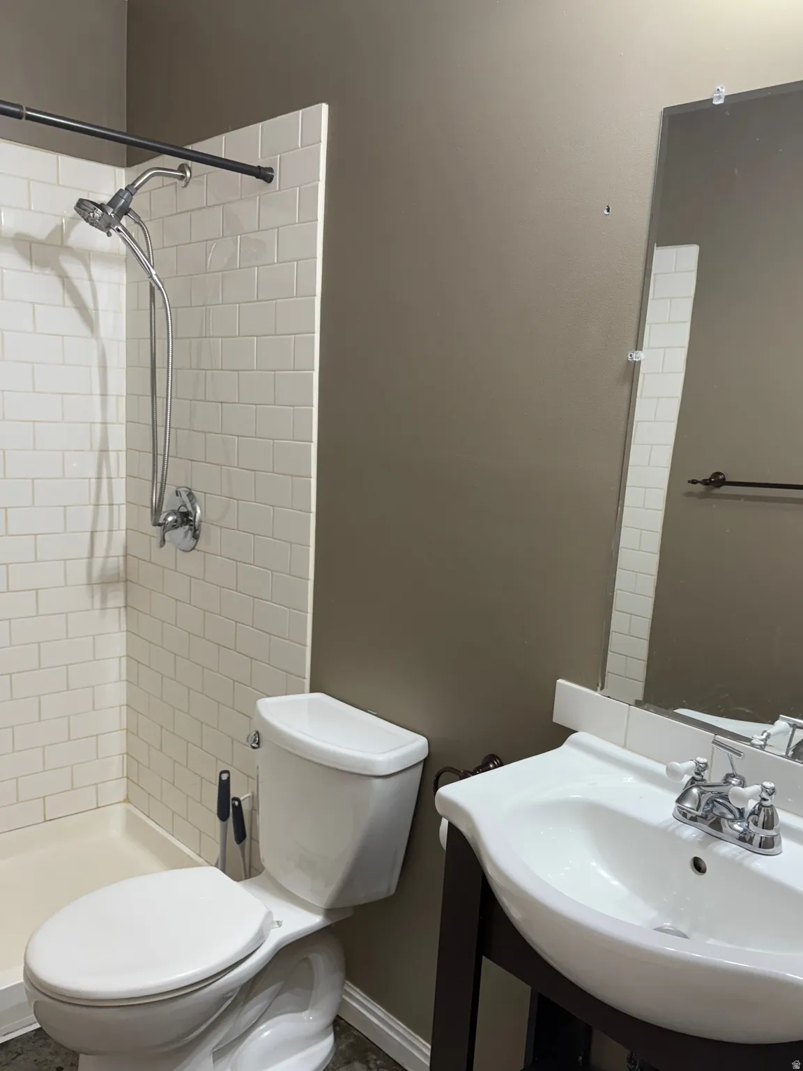 Bathroom with toilet and a tile shower