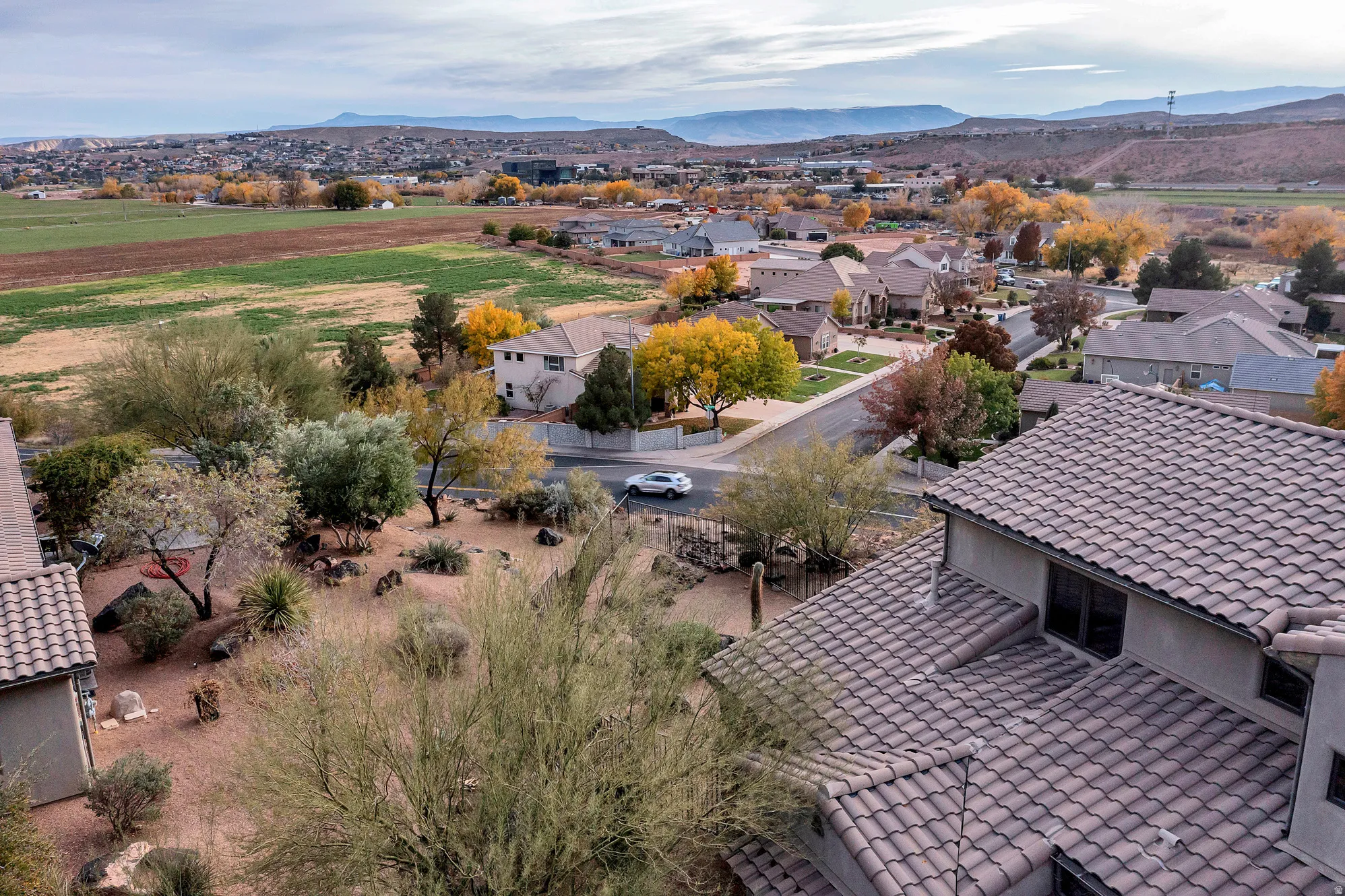 Aerial perspective of suburban area featuring a mountain backdrop