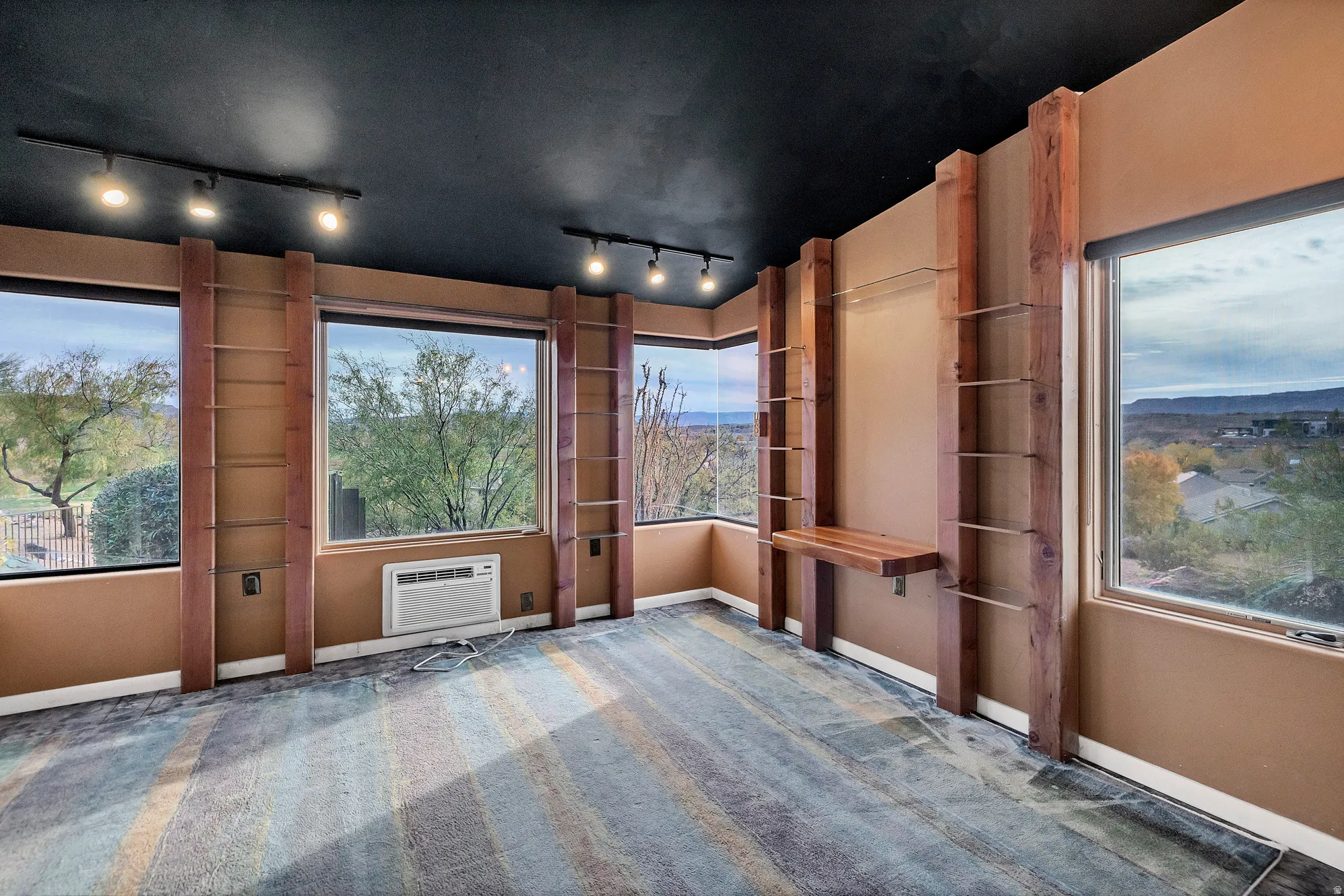 Unfurnished sunroom featuring rail lighting