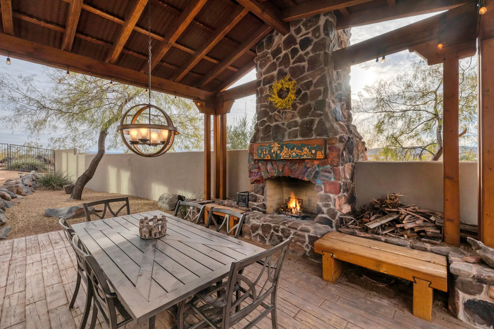 View of patio / terrace with an outdoor stone fireplace and outdoor dining space
