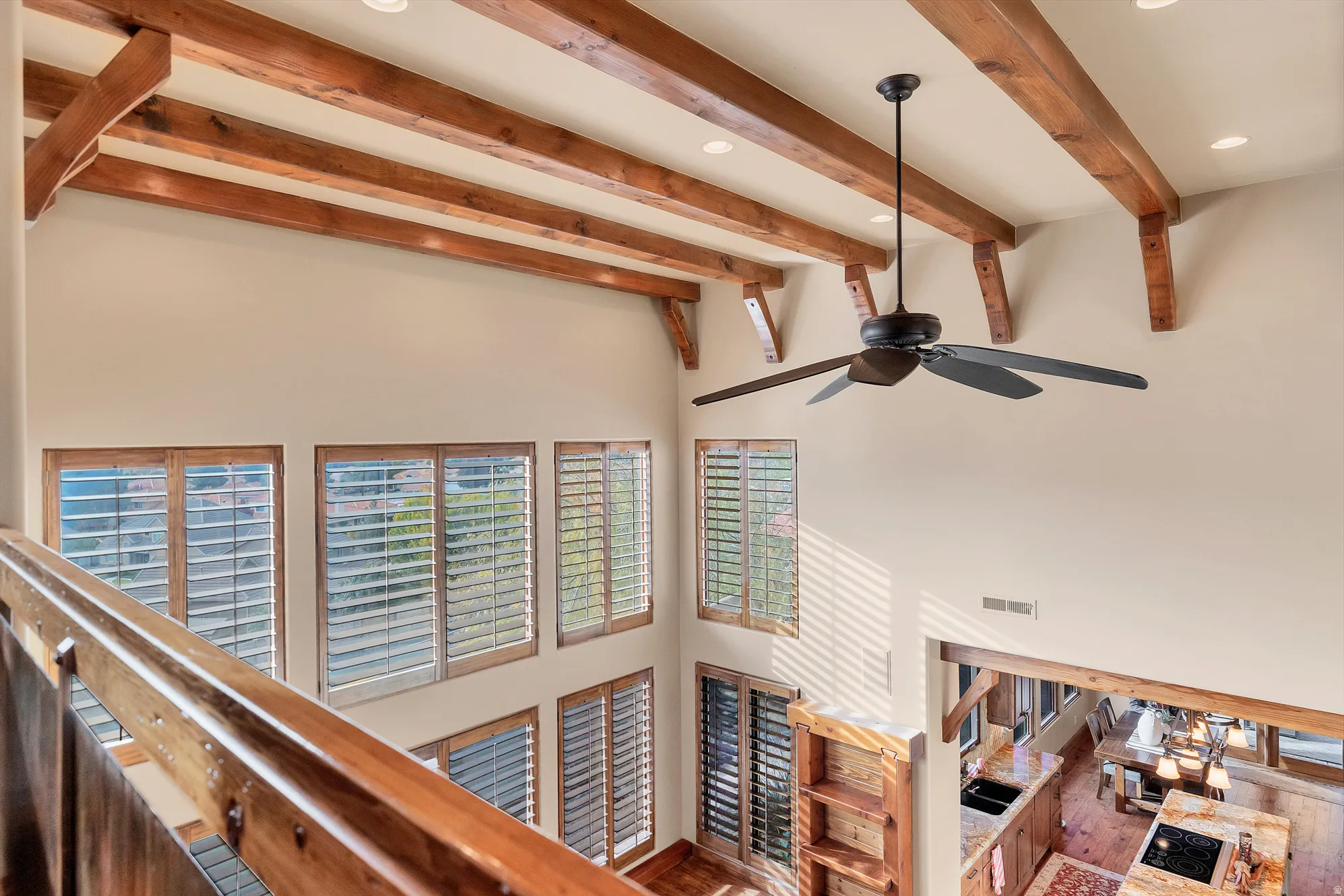 Detailed view of recessed lighting, beam ceiling, and ceiling fan