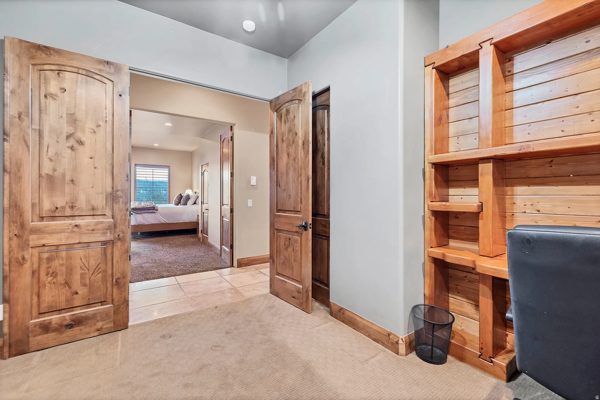 Tiled office space with carpet and baseboards