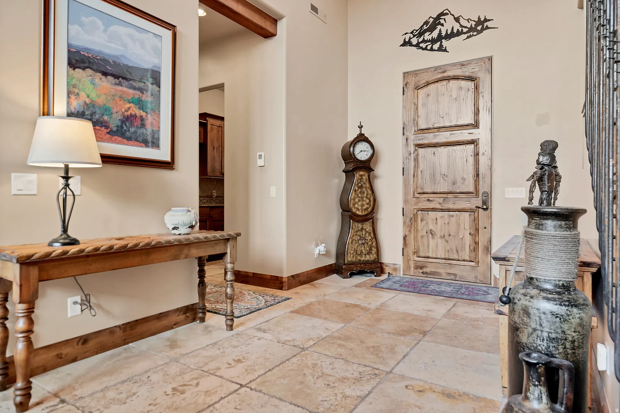 Foyer entrance with baseboards and stone tile floors