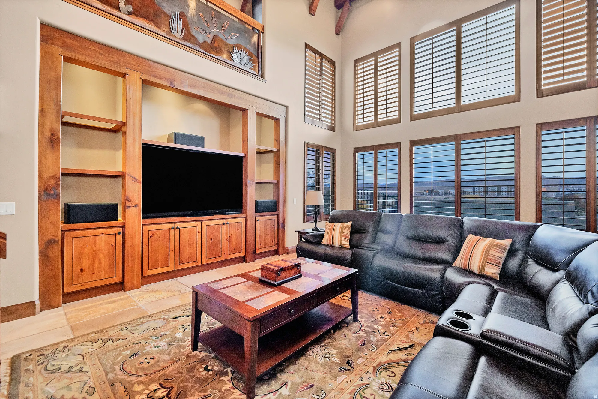 Living area with a towering ceiling and built in features