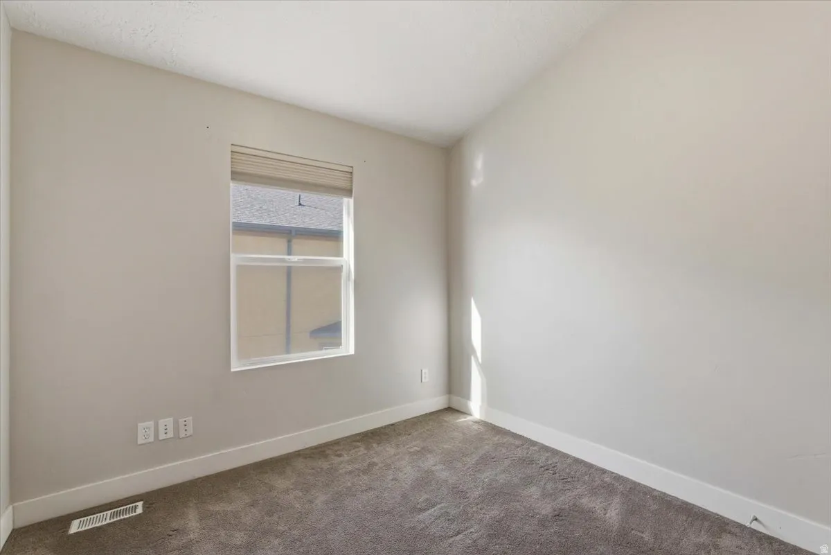 Unfurnished room with baseboards and carpet floors