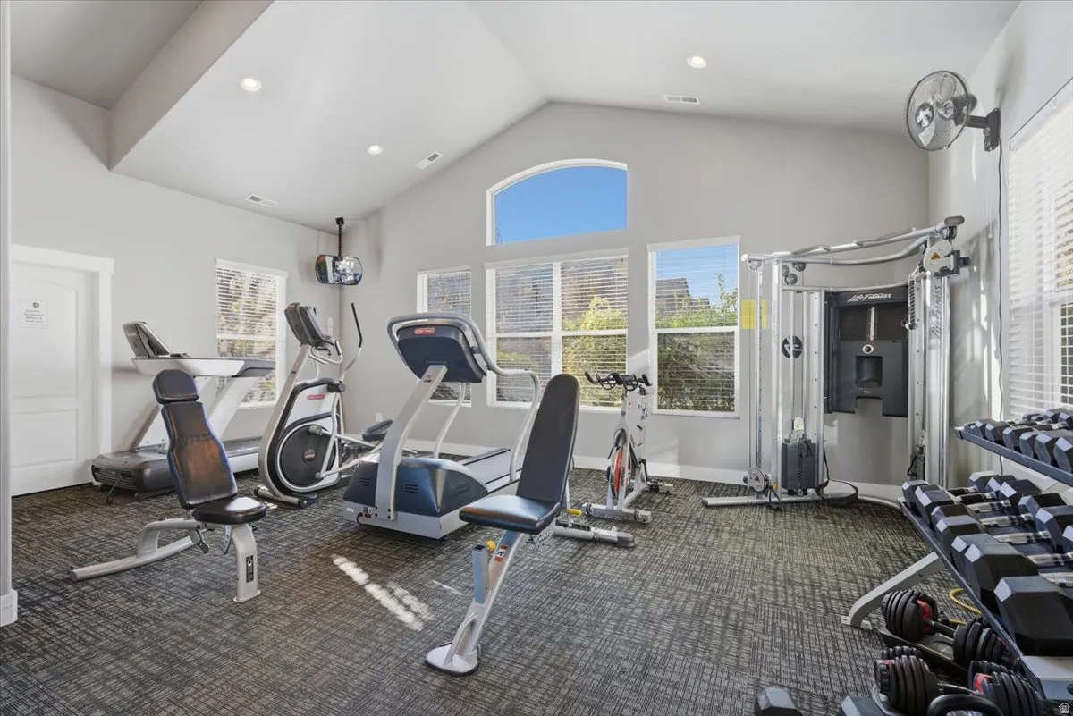 Workout area featuring high vaulted ceiling