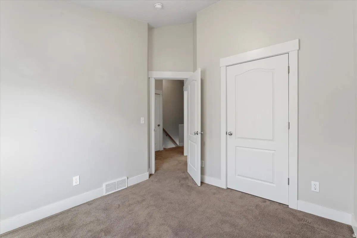Unfurnished bedroom featuring carpet and baseboards
