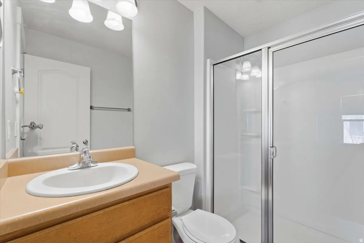 Bathroom featuring vanity and a shower stall