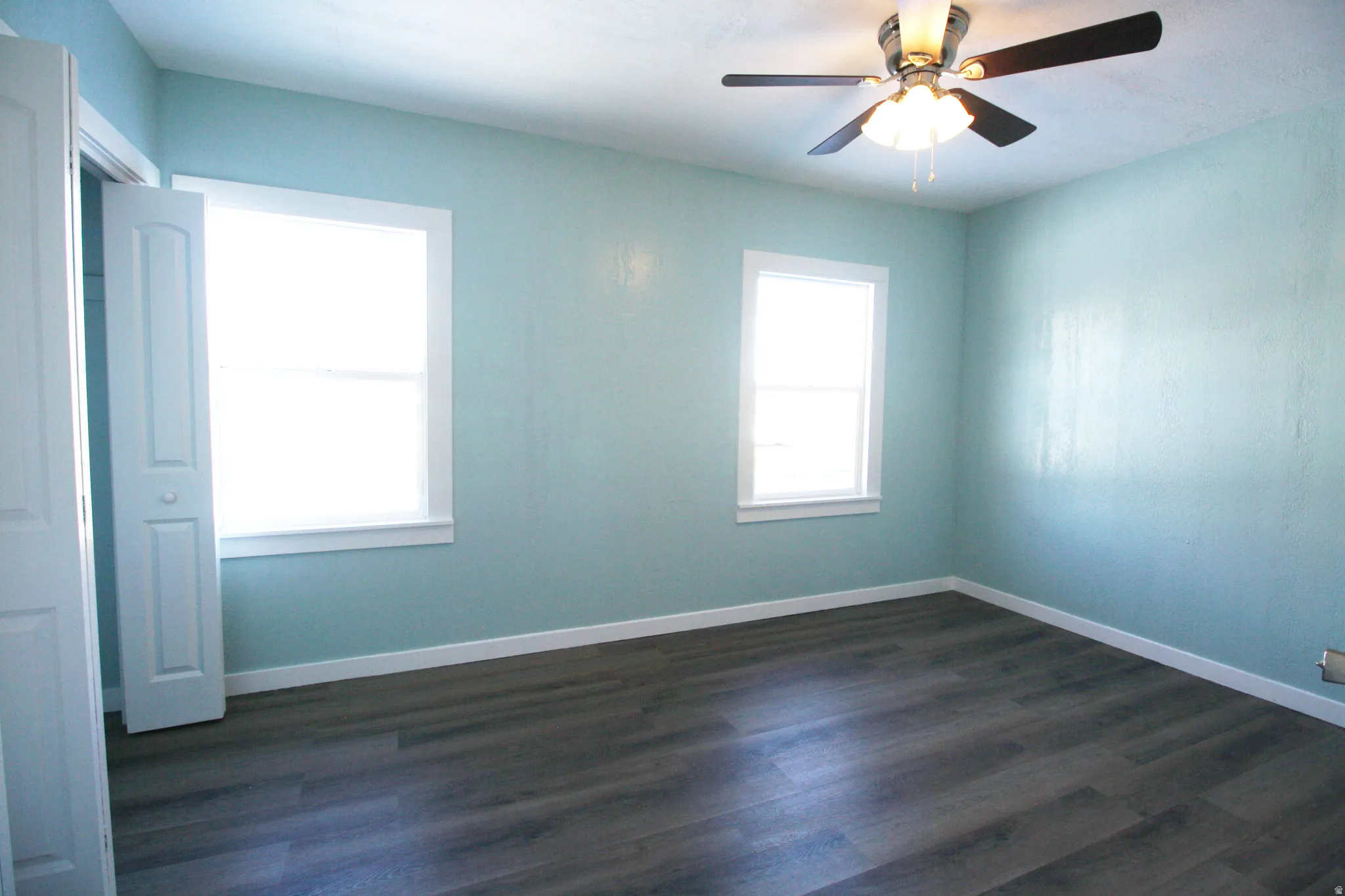 Master bedroom featuring dark wood finished floors and a ceiling fan