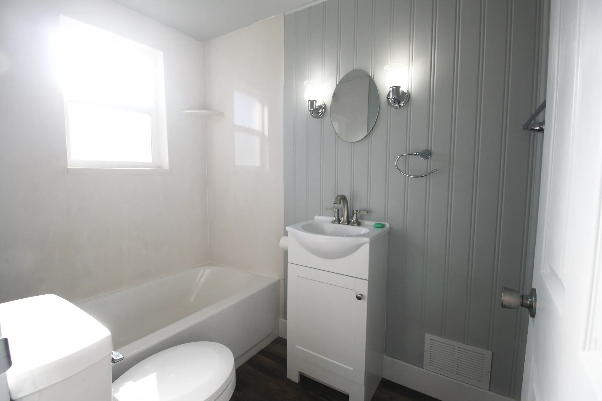 Main Full bath featuring vanity, bathtub / shower combination, and dark wood finished floors