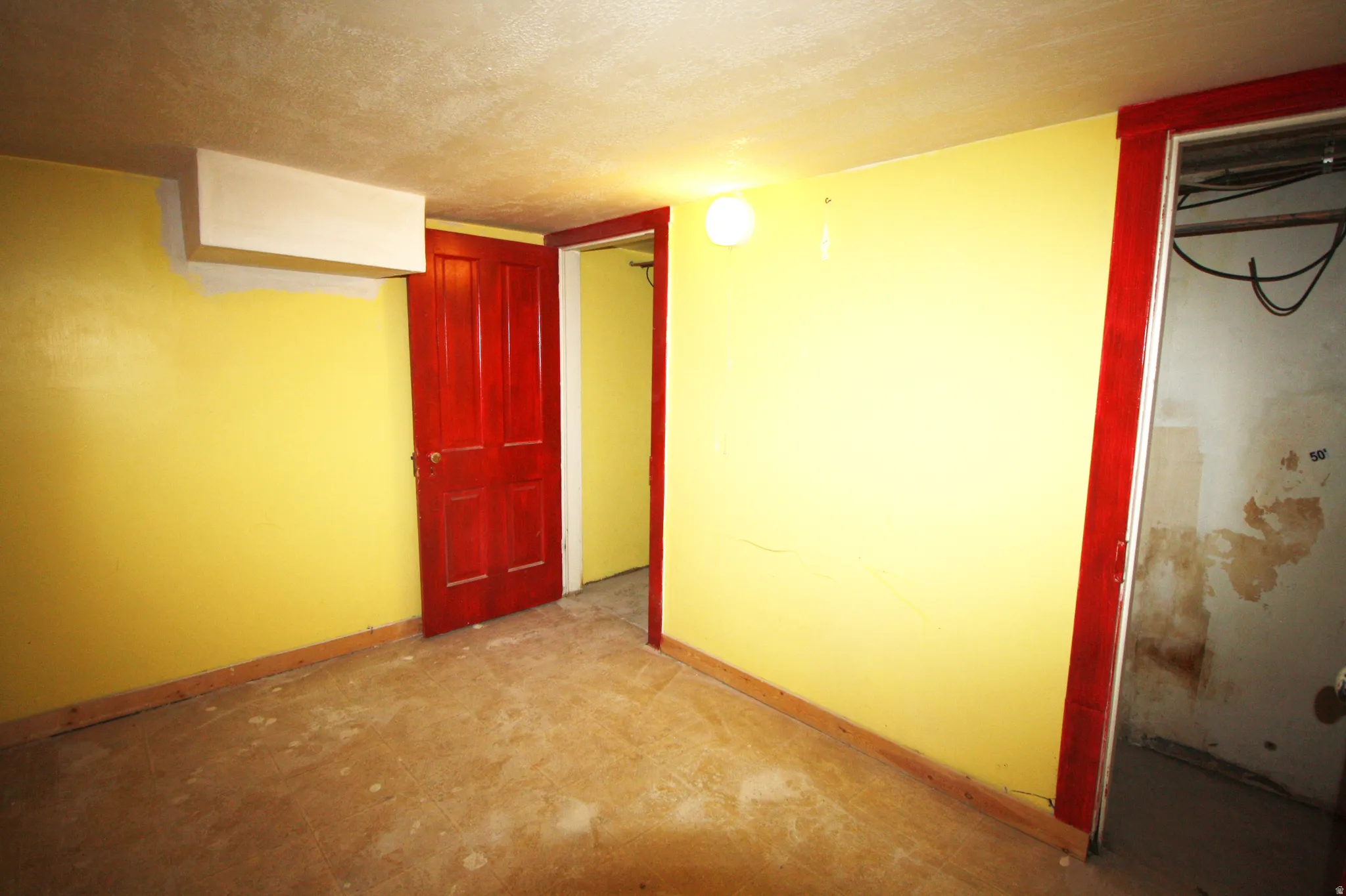 Basement Bedroom 5 featuring a textured ceiling and baseboards