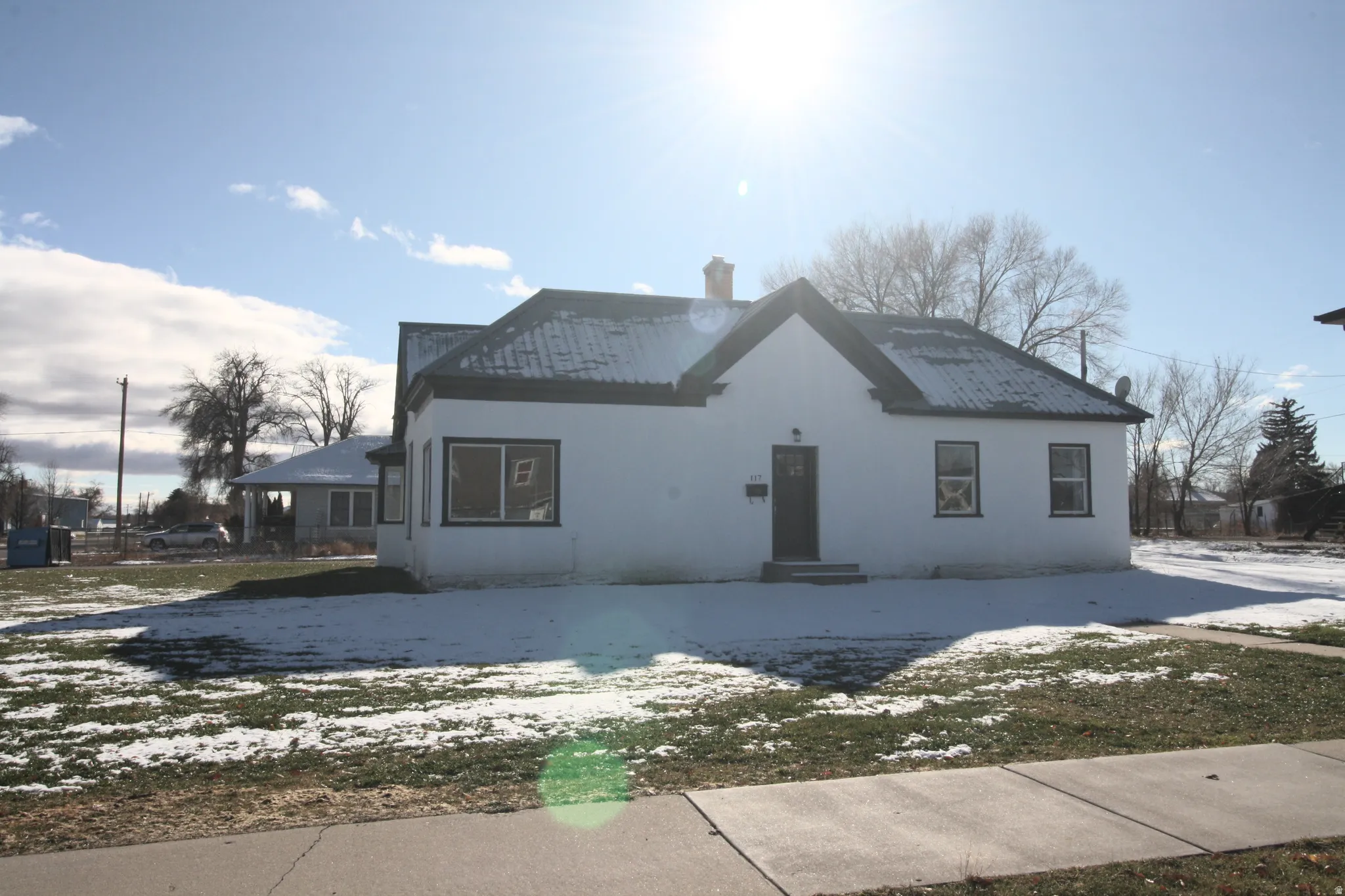View of front of property featuring a chimney and stucco siding