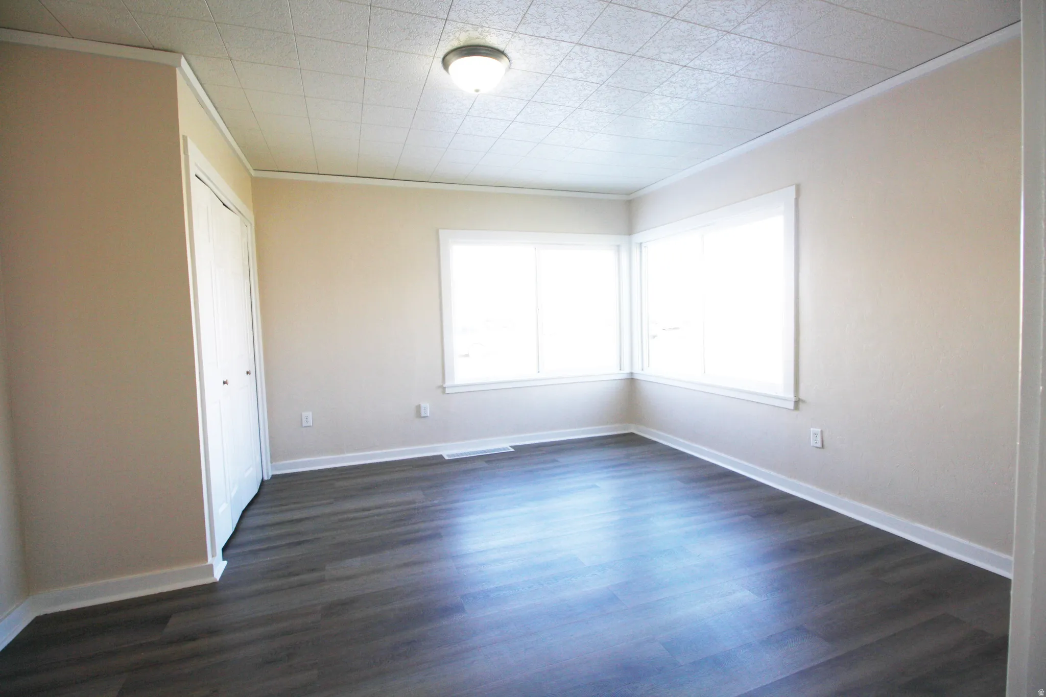 Bedroom 2 featuring ornamental molding and dark wood-style flooring
